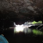 Paddling through a cave that is only accessible during low tide.
